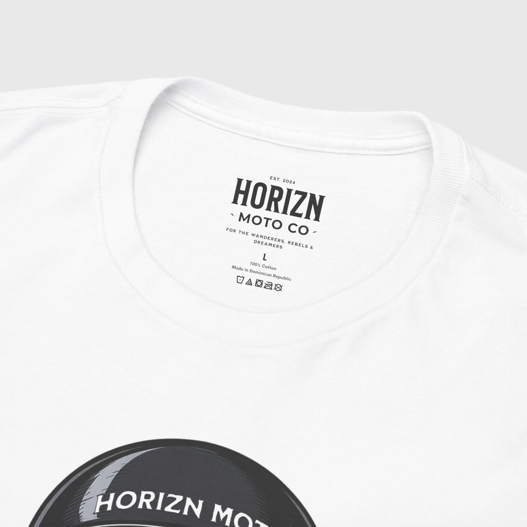 Skull Helmet Heavyweight Moto Tee in white, featuring a bold graphic of a skull with a helmet and crossed moto tools, worn by male model with long dark hair and strong shoulders, perfect for riders and modern rebels.