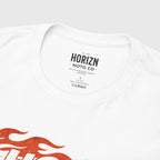 Flame Skull Moto Graphic Tee, heavyweight cotton t-shirt worn by a man with long blonde hair, featuring bold flame and skull graphic in orange on crisp white backdrop, capturing the spirit of freedom and rebellion.