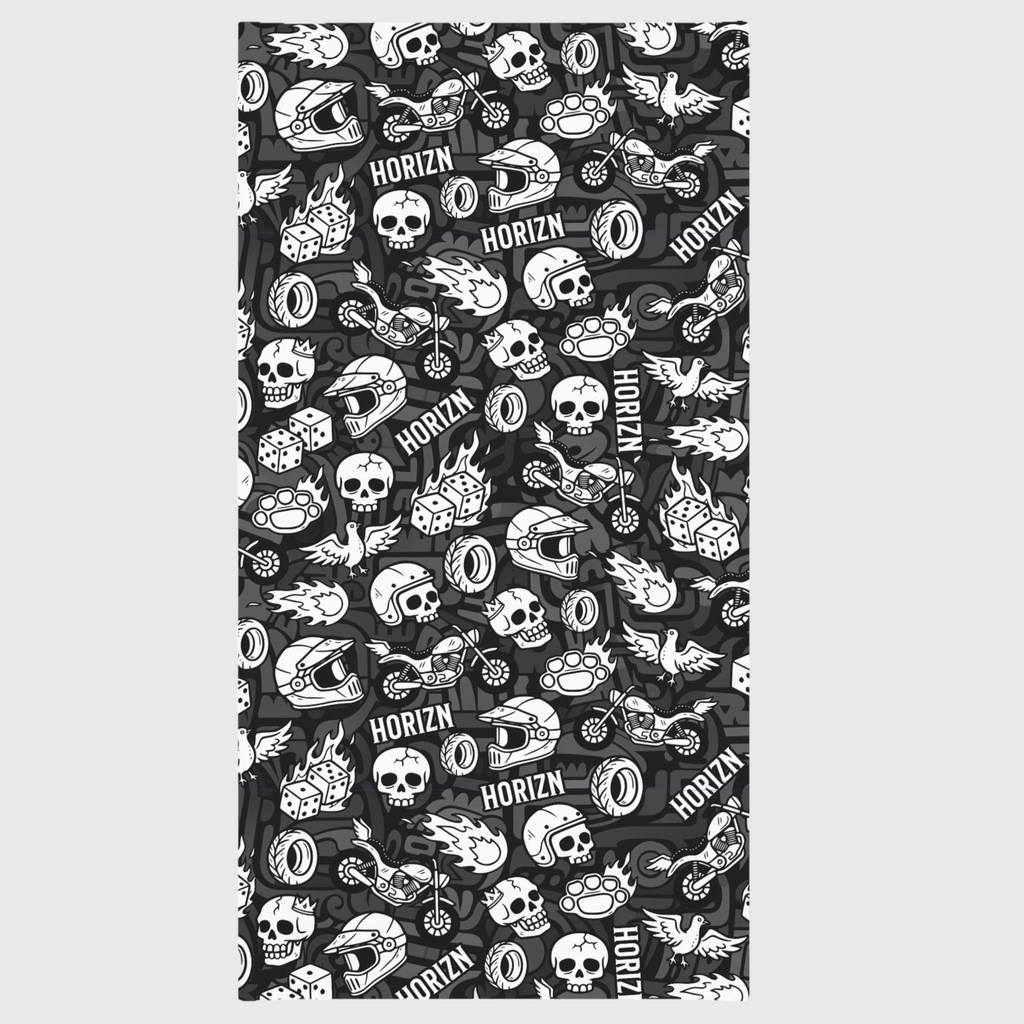 Black and white Skull & Flame Moto Gaiter worn by a woman with wavy dark hair, featuring skulls and flames, perfect for motorcycle riding and outdoor adventures.