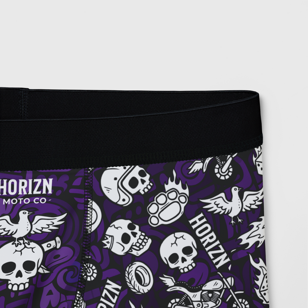 Men's purple moto skull boxer briefs featuring all-over graphic design of skulls, flames, and helmets. Perfect for riders seeking comfort and style.