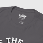 Back view of a man with a beard wearing a grey heavyweight Chase the Horizn Skull Rider Tee, showcasing premium cotton material and relaxed fit for riders.