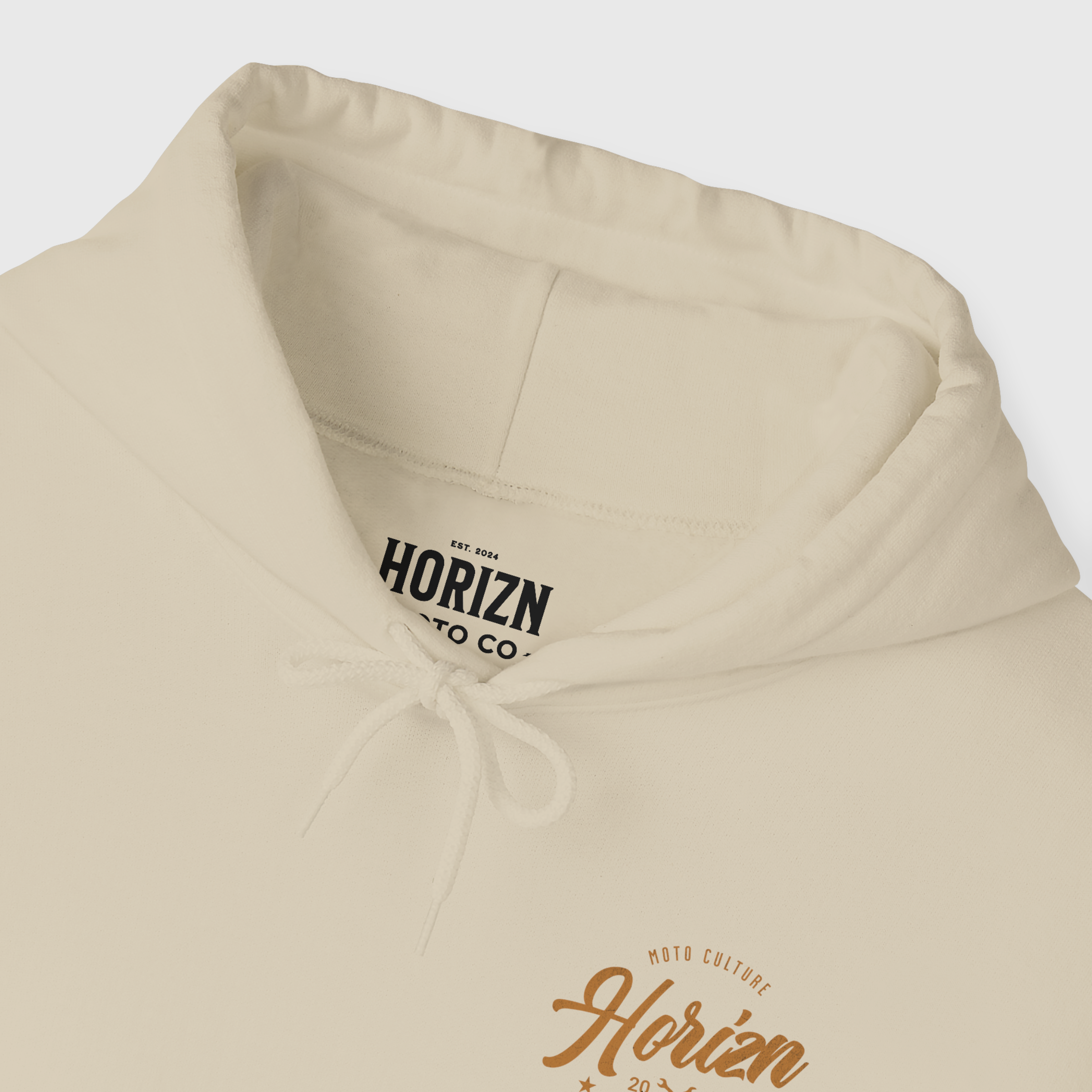 Male model wearing Moto Culture Heavyweight Hoodie in Horizon Beige, featuring back graphics with 'Horizon' and crossed wrenches, relaxed fit perfect for motorcycle riders.