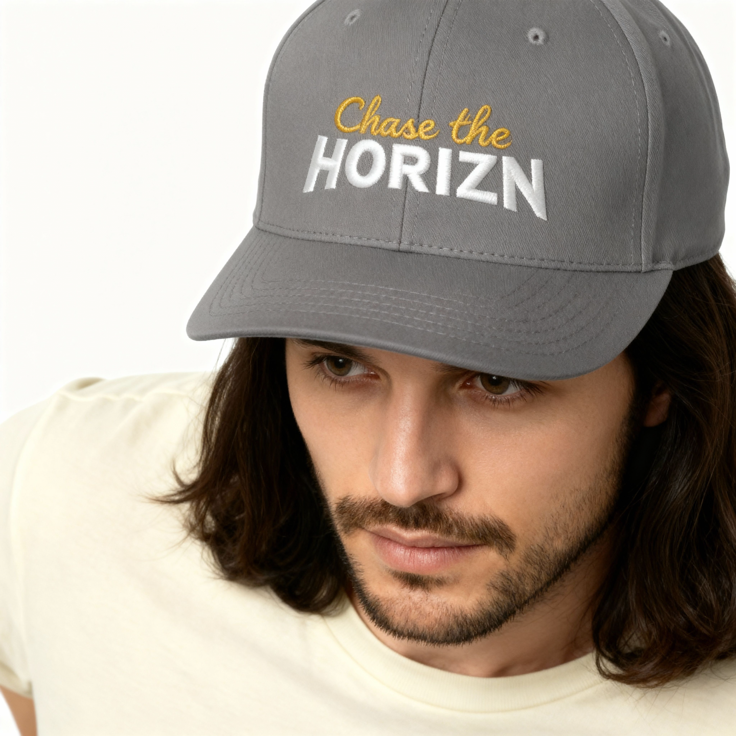 Chase the Horizn embroidered moto cap in dark grey featuring bold yellow and white lettering, perfect for adventure seekers and moto enthusiasts.