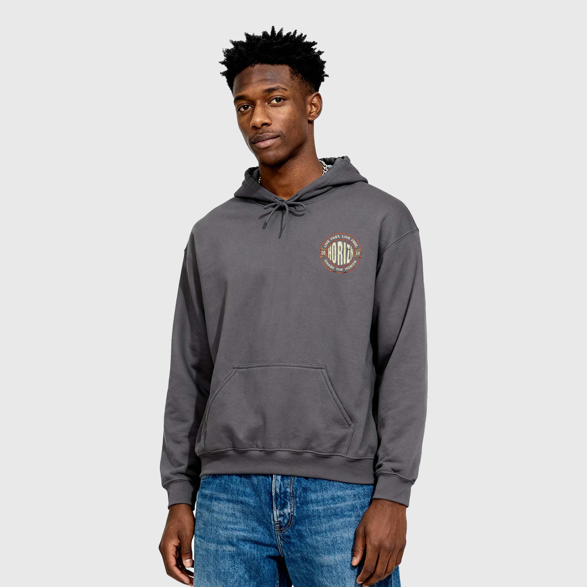 Heavyweight Live Fast Hoodie in asphalt gray with distressed moto graphic, worn by male model with short hair, showcasing 'LIVE FAST. LIVE FREE' and 'CHASE THE HORIZN' on the back.