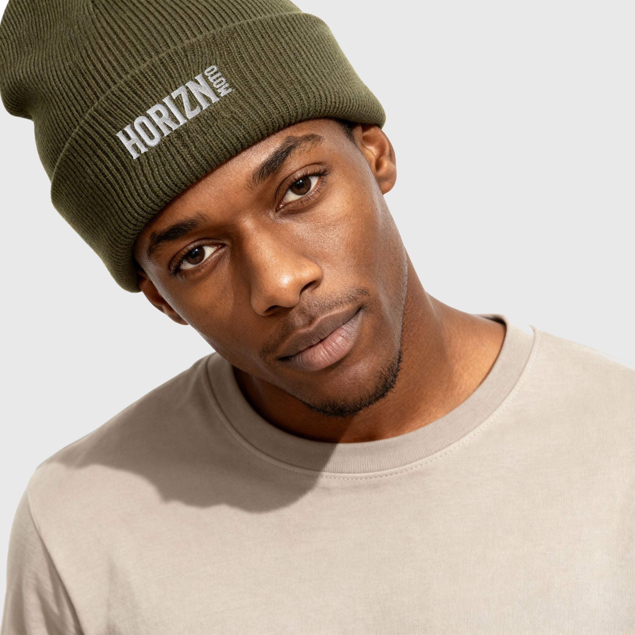 Ribbed knit moto beanie in olive green with minimalist HORIZN moto logo, designed for colder rides and streetwear styles.