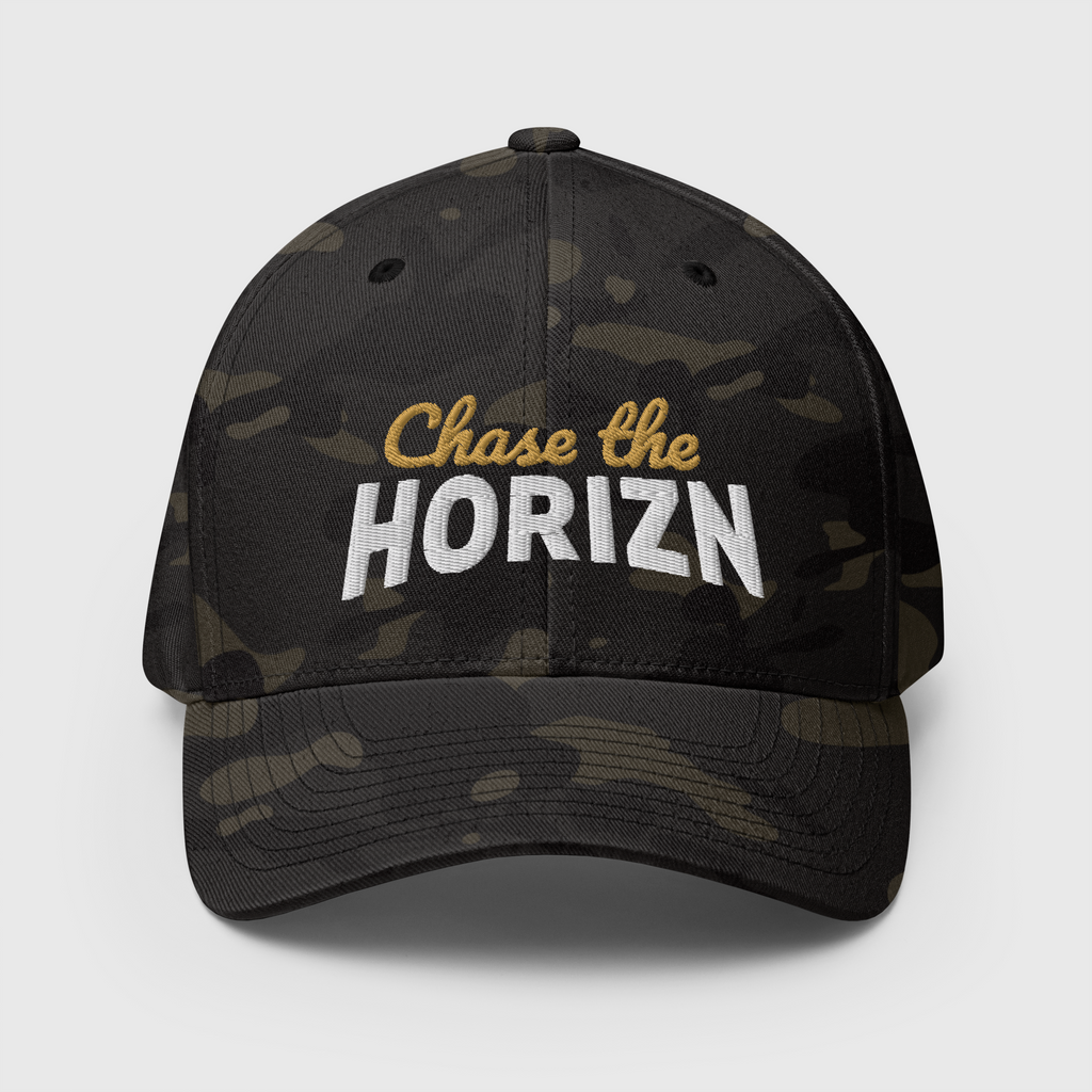 Front view of the Multicam Black camouflage Chase the HORIZN Flexfit cap, with gold-and-white embroidered lettering and a curved visor.