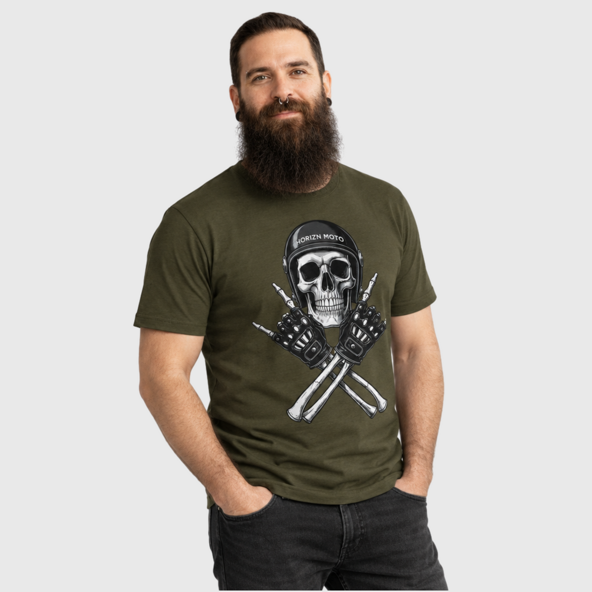 Model wearing the army green Rebel Bones motorcycle tee with the skull helmet and crossed-gloves print.