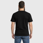 Rear view of a model wearing the black Rebel Bones Moto Tee, showing its plain back and fit.