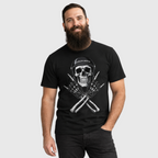 Bearded model wearing the black Rebel Bones motorcycle graphic tee, showing the helmeted skull and crossed-gloves print.